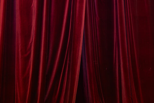 Texture of Luxury Dark Red Velvet Curtains with Vertical Drapery