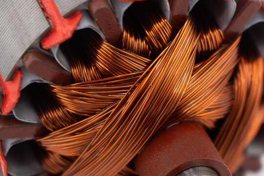 Electric DC motor rotors with copper commutator and coil wire winding texture background. Magnet engine.  Starter anchor motor.