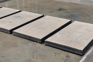 Abstract View of Concrete Slabs in a Row on a Wet Rough Surface