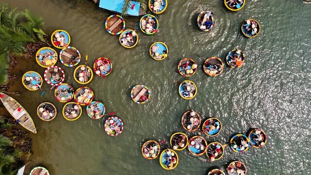 Aerial view of tourists enjoying a tour on round basket boats in the coconut forest of the thu bon river in hoi an, Vietnam