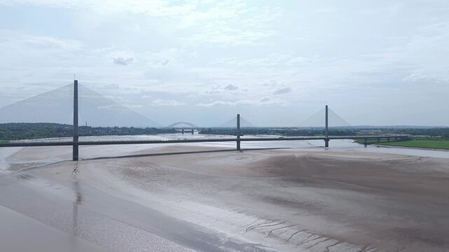 Liverpool, Merseyside, UK, June 19, 2025; Aerial 4K video footage of the Mersey Gateway toll bridge with stunning views over the River Mersey, Liverpool, UK.