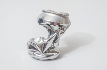 Crushed aluminum can isolated on white background, recycling concept.