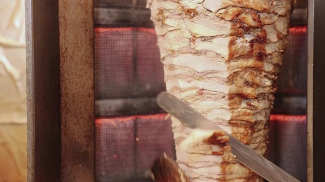 Chef Cutting Juicy Shawarma Meat in Restaurant Kitchen