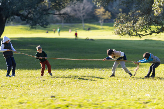 Children playing tug of war game in park