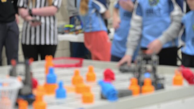 Defocused Students participate in a robotics competition and present their projects in a gym on a Saturday afternoon