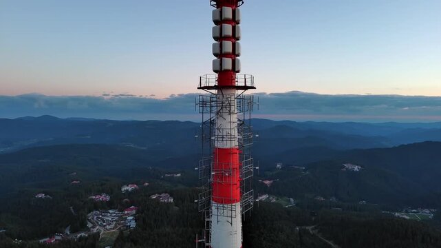 Tower Snezhana on peak of Snezhana covered with spruce forests in Rhodope mountains