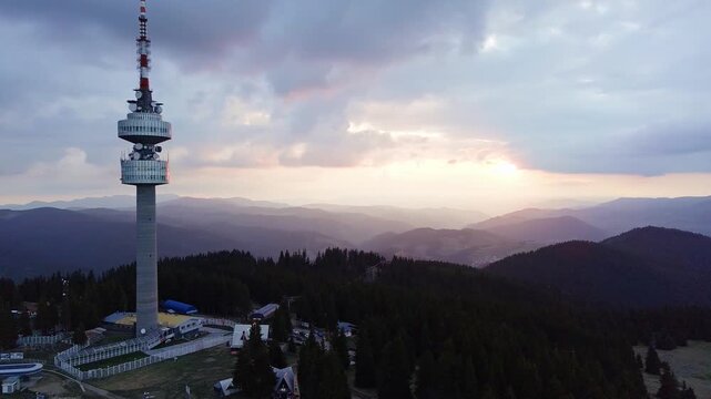 Tower Snezhana on peak of Snezhana covered with spruce forests in Rhodope mountains