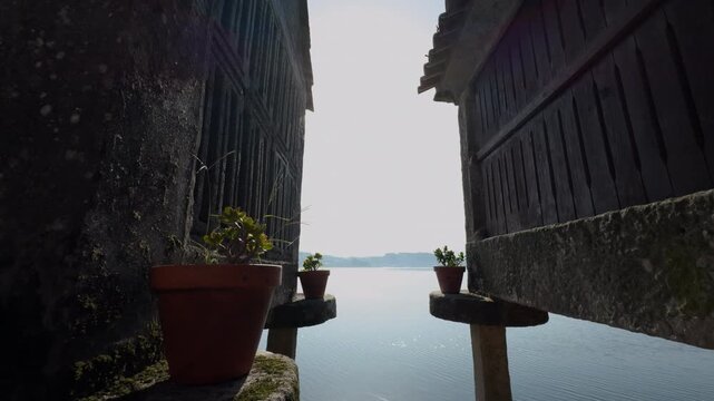 Backlit Galician Horreos by the Ria at Golden Hour