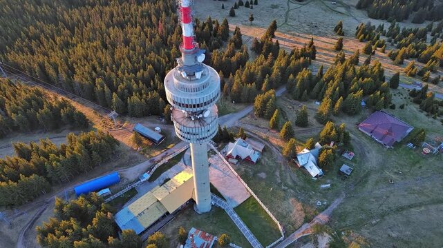 Tower Snezhana on peak of Snezhana covered with spruce forests in Rhodope mountains