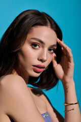 Fototapeta premium Beautiful young woman showcasing modern fashion against a vibrant background