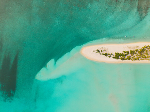 Aerial view of a crescent of pristine white sand fringed with verdant greenery, embraced by the turquoise waters of the Indian Ocean, Dhidhdhoo, Thiladhunmathi Atoll, Maldives.