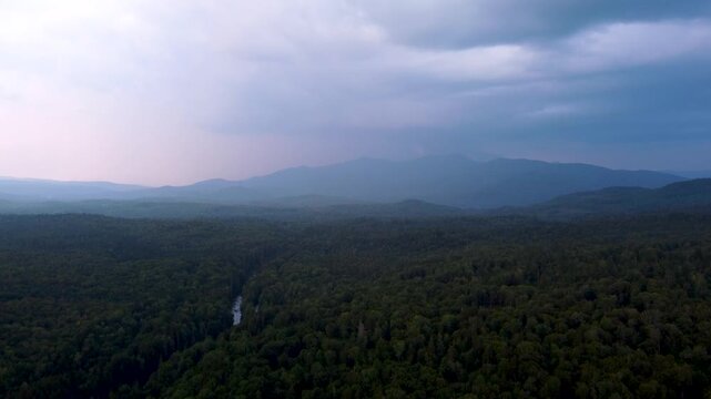 Maidstone, Vermont, an aerial view of the dense northern forest and rolling green mountains of the Northeast Kingdom after sunset.