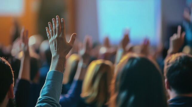 People raising hands in a meeting