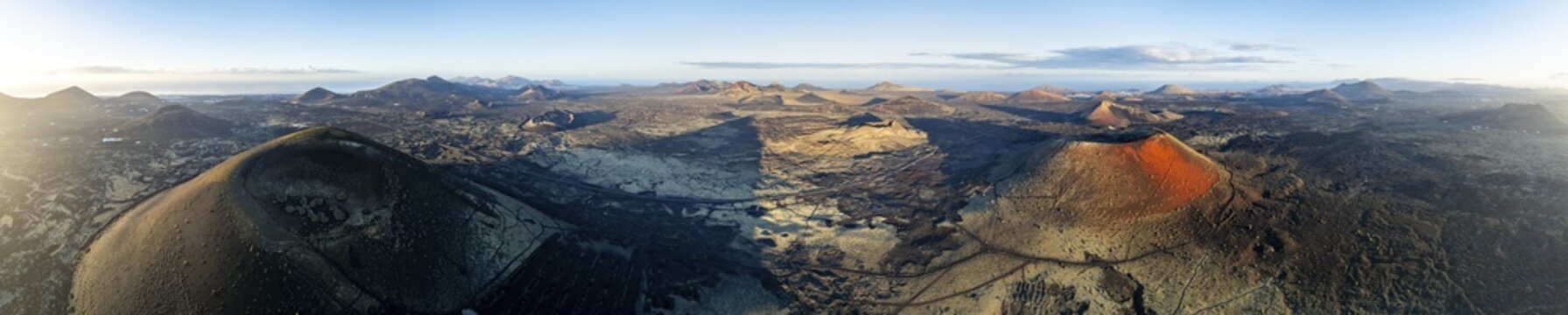 Picturesque volcanic landscape with volcanic craters and lava fields in morning light, Monta&ntilde;a Negra volcano, Caldera Colorada and Volc&aacute;n de Las Nueces, Los Volcanes Natural Park, aerial view, Lanzarote, Canary Islands, Spain