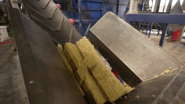 Production of cellulose insulation from recycled paper, showing the continuous flow of material in a processing machine