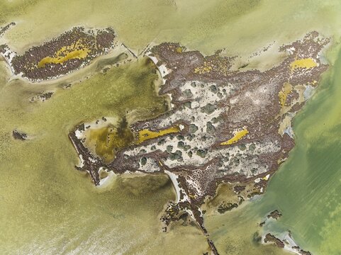 Islands and conspicuous patterns at the shallow lagoon Salinas de Cerrillos, aerial view, drone shot, Almer&iacute;a province, Andalusia, Spain
