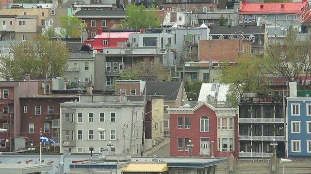 Urban housing in Quebec City, Quebec, Canada on an overcast afternoon. Quebec provincial flag.