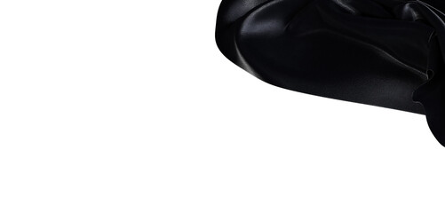 Close up abstract shot of black shiny fabric with beautiful texture and subtle shadows against a clean white backdrop. P © vegefox.com