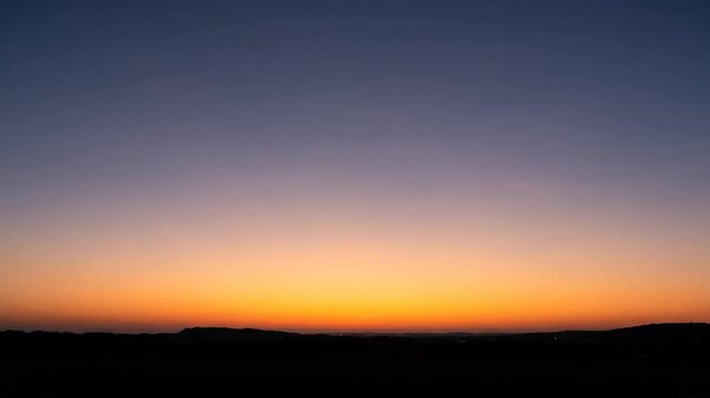 Time lapse sequence of a vibrant sunrise presented as a three panel triptych. Beautiful gradient sky from deep blue to warm orange over a dark horizon silhouette