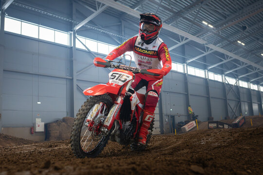 Latvia, Riga August 27, 2025,  regular training Motocross racer riding dirt bike in indoor arena