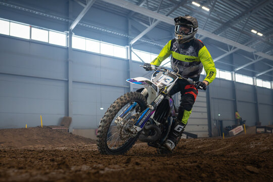 Latvia, Riga August 27, 2025,  regular training Motocross rider performing a jump in an indoor arena