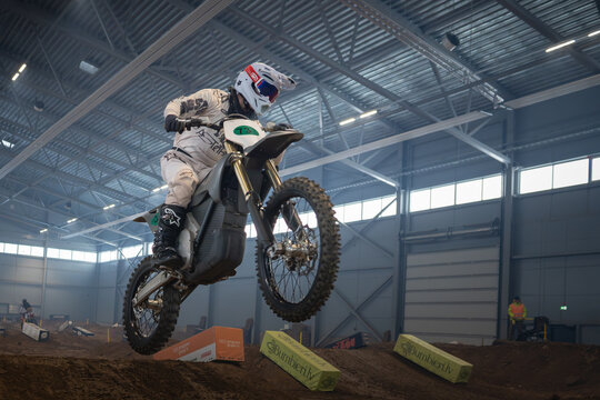 Latvia, Riga August 27, 2025,  regular training Motorcyclist performing a jump in an indoor arena