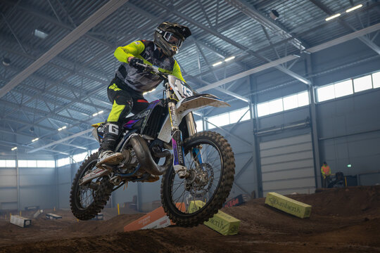 Latvia, Riga August 27, 2025,  regular training Motocross rider performing jump on indoor track