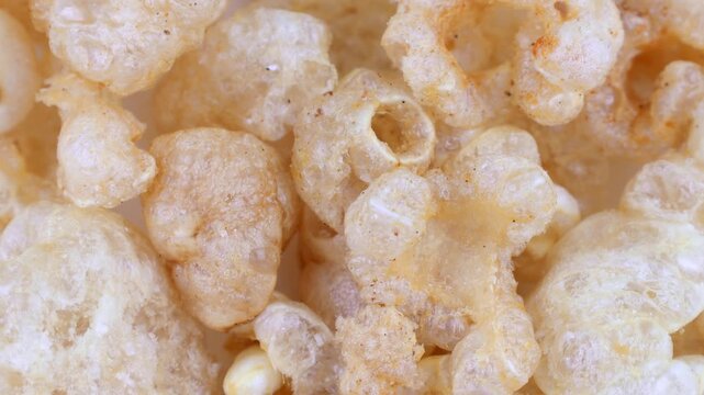 Deep fried chicharron or chicharrones pork rinds circle rotation close up