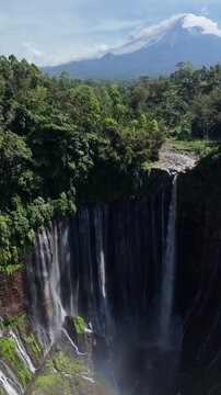 Vertical Aerial View of Tumpak Sewu Waterfall with Mount Semeru Volcano view