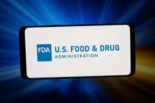 Stuttgart, Germany - 02-27-2026: In this photo illustration, the logo of US agency Food and Drug Administration (FDA) is displayed on a smartphone in front of abstract background on computer screen.