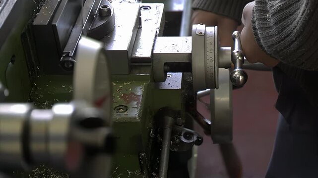 Student Operating Industrial Machine in Technical School Workshop