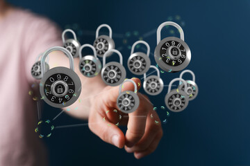 Concept of cybersecurity with a hand interacting with digital padlocks, representing data protection and online safety.