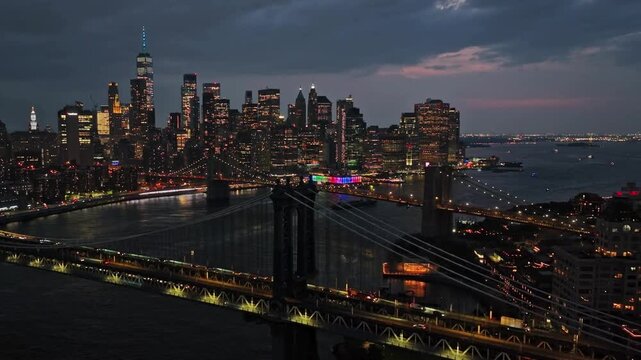 Breathtaking view of New York City, Evening. View of the Manhattan skyline, East river and Brooklyn bridge. The lights of the skyscrapers are turns on. Global Business, Urban Nightlife