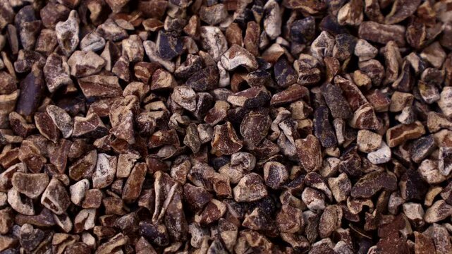Roasted brown crushed cocoa nibs texture circle rotation close up