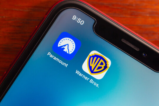 Quito, ECUADOR - Mar 2 2026 : Close up of a smartphone screen showing Paramount and Warner Bros icons on a home screen, representing streaming media and entertainment brands.