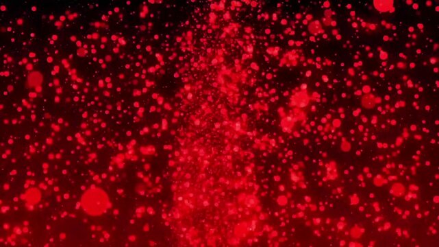 Vibrant red particles explode in dynamic motion against dark background