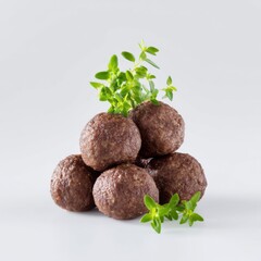 Freshly Made Healthy Meatballs with Green Herb Garnish on a Clean White Background