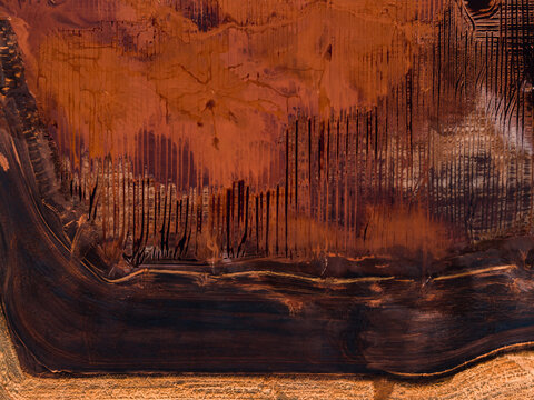 Aerial view of the stark contrast of the rusty red earth meets the dark, still waters in an industrial landscape, Aluminium Refinery, Western Australia, Australia.