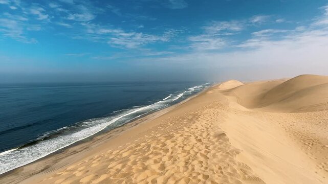 Sandwich Harbour in Namibia at the coast of the Atlantic Ocean. Sandy beach. Sandwich Harbor roundtrip daytime car tour