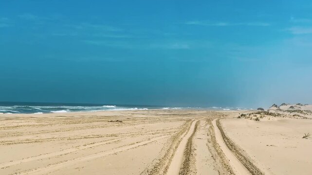 Sandwich Harbour in Namibia at the coast of the Atlantic Ocean. Sandy beach. Sandwich Harbor roundtrip daytime car tour