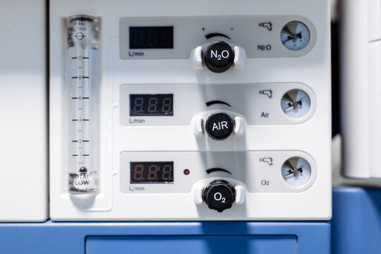 Medical gas delivery system featuring flow meters and pressure gauges for nitrous oxide, air, and oxygen in a modern hospital setting