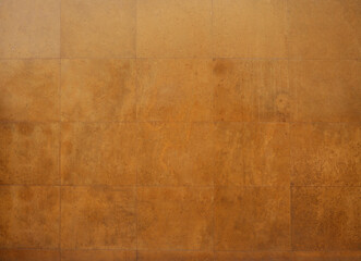 Obraz premium Brown squares form a seamless tile background for textures and design elements tiled wall made of small square tiles in various shades of brown. tiles pattern, creating a textured abstract background