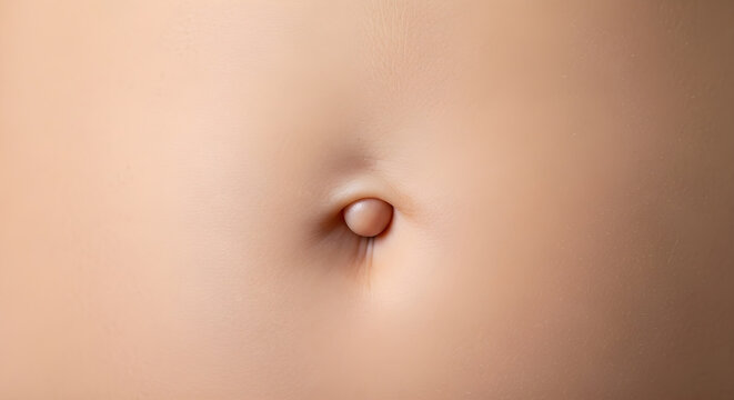 A close-up view of a human navel on a person's abdomen, capturing the intricate details of the belly button from a frontal perspective.