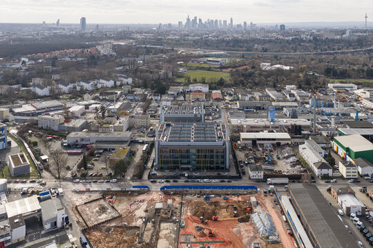 Aerial view of Mainova WebHouse GmbH amid a sprawling industrial landscape, with a distant skyline punctuating the horizon, Frankfurt am Main, Hessen, Germany.