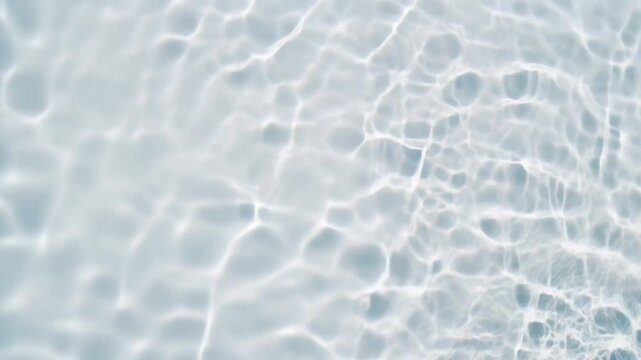 Water ripples in slow motion create shimmering light caustics on a clean blue pool surface in this bright minimalist stock video background for summer.