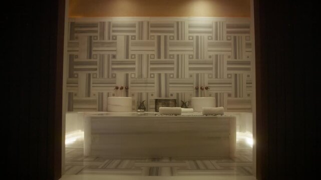 Empty luxurious and traditional hammam spa room with marble and ornate tiling for relaxation and wellness