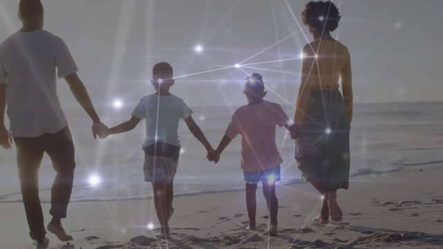 Family of four walking to surf, sun activating tech overlay flaring near shapes then settling