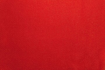 Fototapeta premium ​Red fabric texture background, close-up of soft textile material.