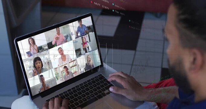 Man on right checking stocks, finance overlays appearing midway over laptop, scrolling trackpad