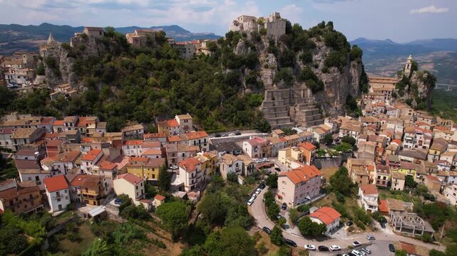 Bagnoli del Trigno aerial 4k view of castle and church on cliff in Italy. San Felice fortress on rocky peak in Molise hidden gem. Medieval village and limestone mountain scenery
